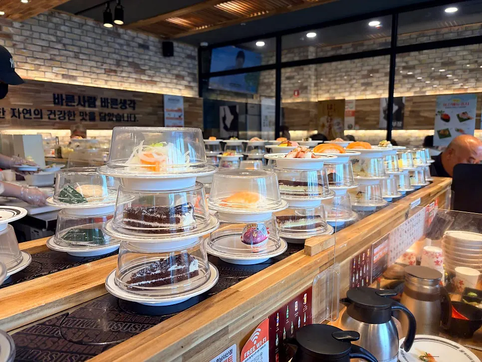 Dessert plates of cake and fruit on the conveyor rail