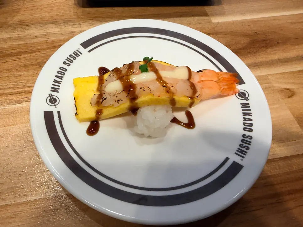 A plate of sweet shrimp and egg sushi