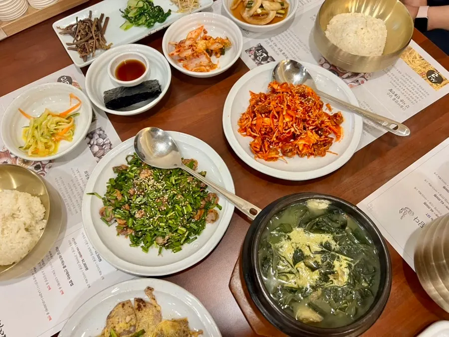 Japchae, stir-fried pork, and chicory salad side dishes