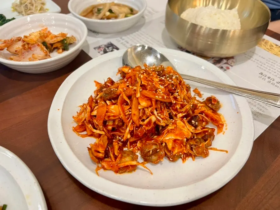 Vinegar-dressed cockles tossed with cabbage and gochujang sauce