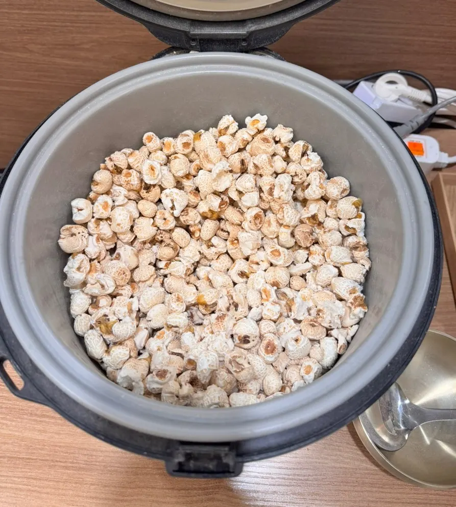 Warm popped corn dessert served in a rice cooker