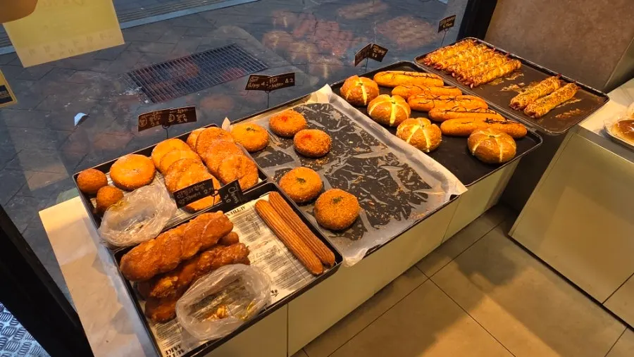 Browsing the bread selection at Milbat Bakery Pyeongchon