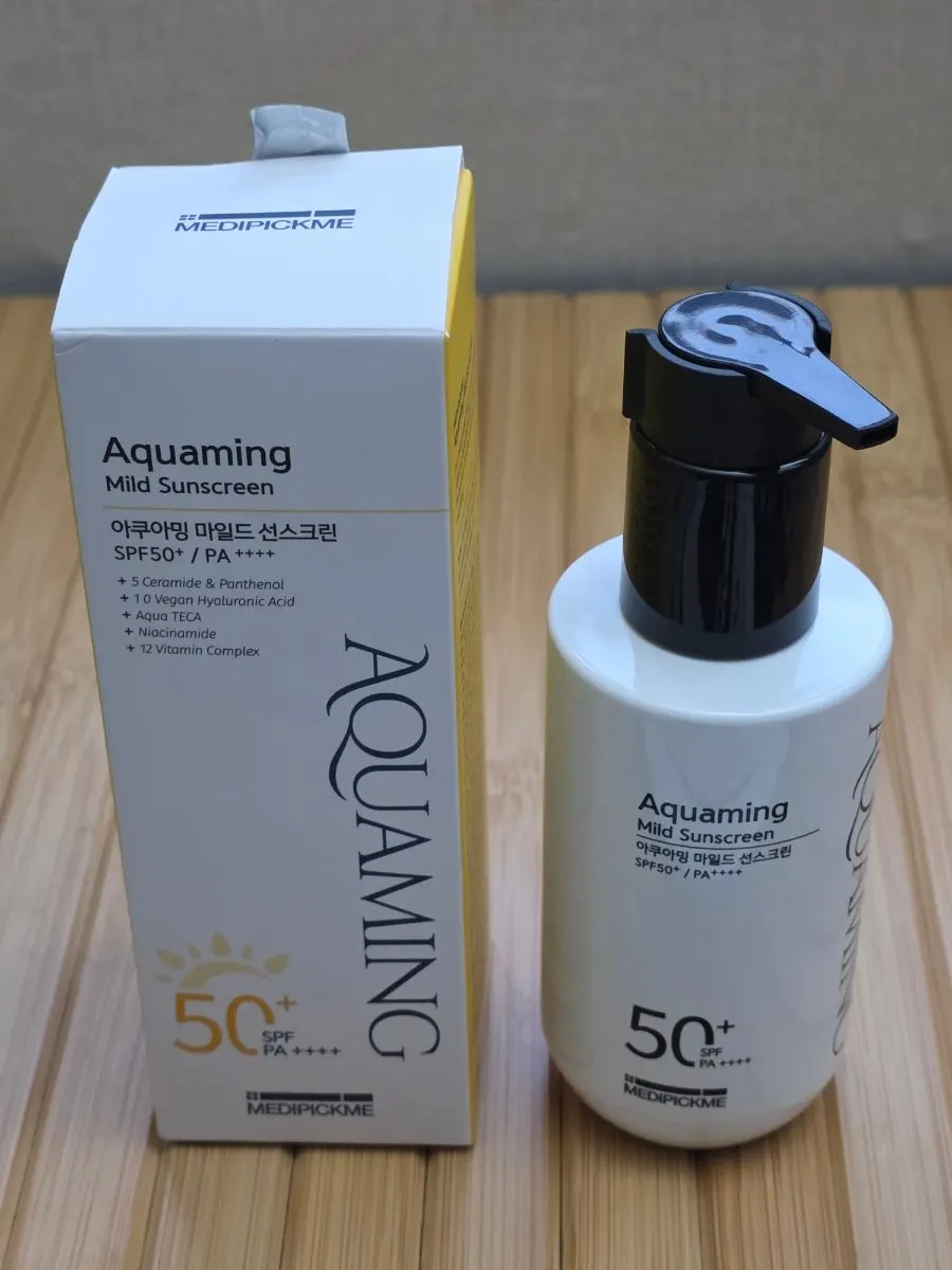 Face-and-body sunscreen bottle held in hand