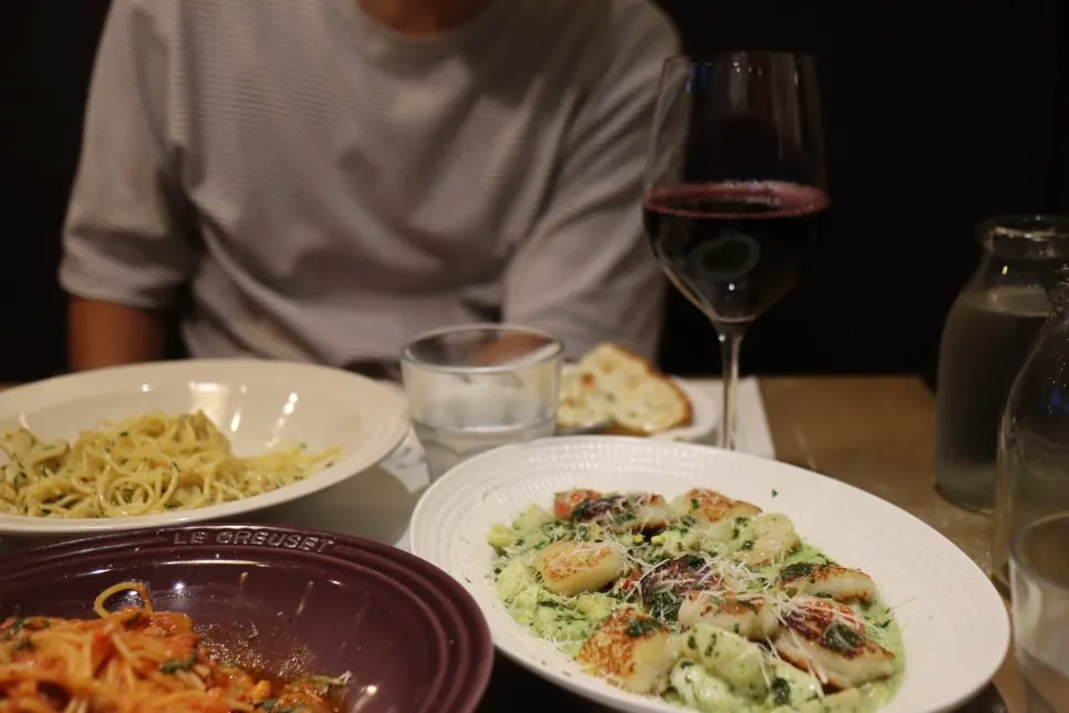 A glass of wine set beside the pasta