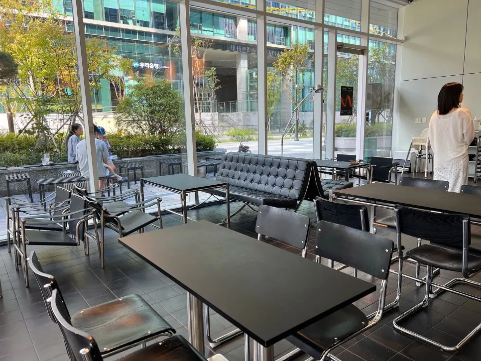 Interior seating at Minimale Coffee Roaster with floor-to-ceiling windows