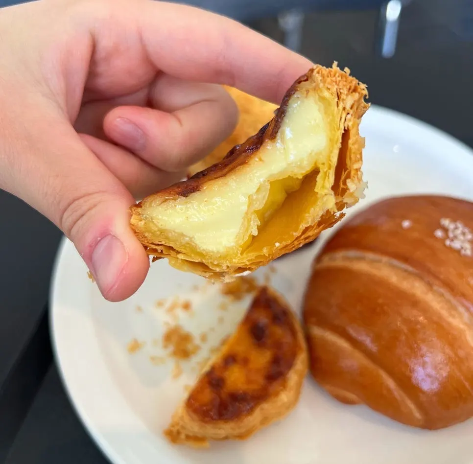 Plate with egg tart and salt bread together