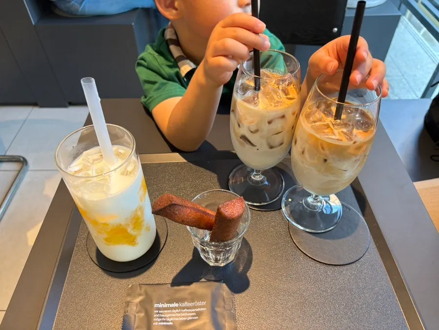 Kids showing interest in the drinks at the table
