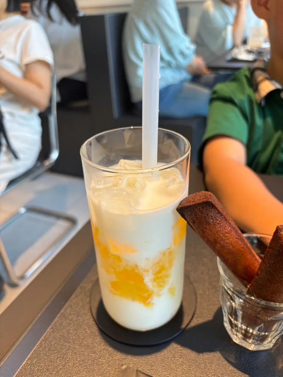 Child's hand stirring the Helsinki latte