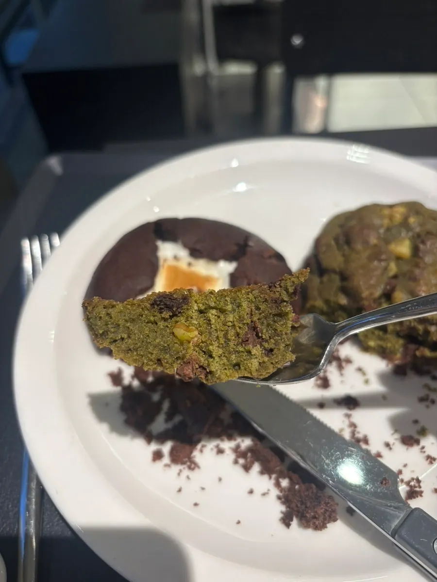 New York cookie placed alongside the latte