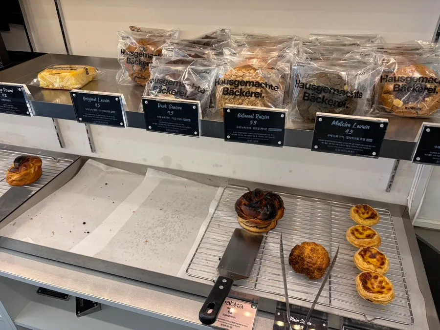Bakery display mostly sold out on a weekend afternoon