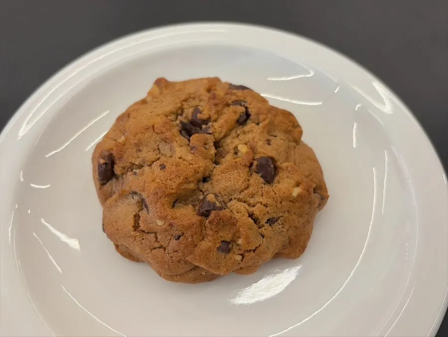 Thick handmade New York-style levain cookie served on a plate