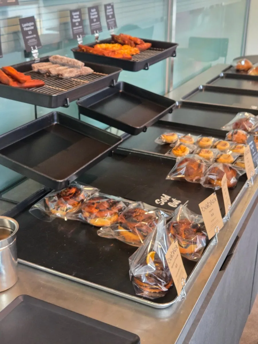 Display case of egg tarts and salt bread