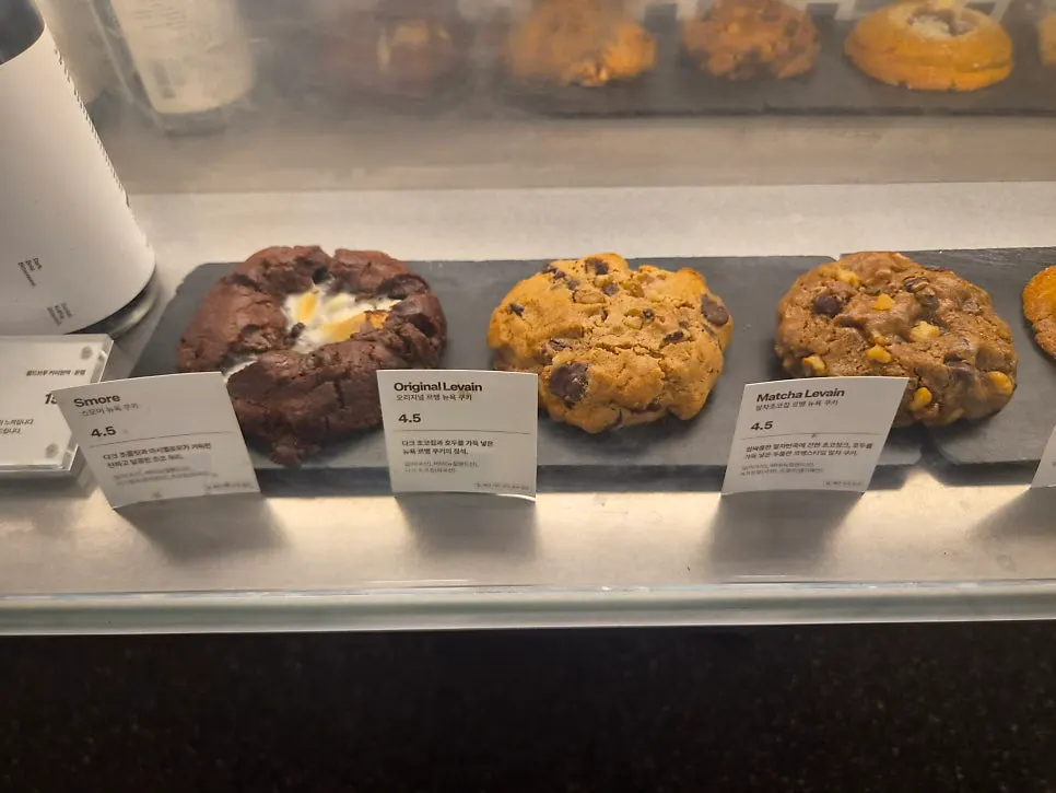 Bakery display case with cookies and egg tarts
