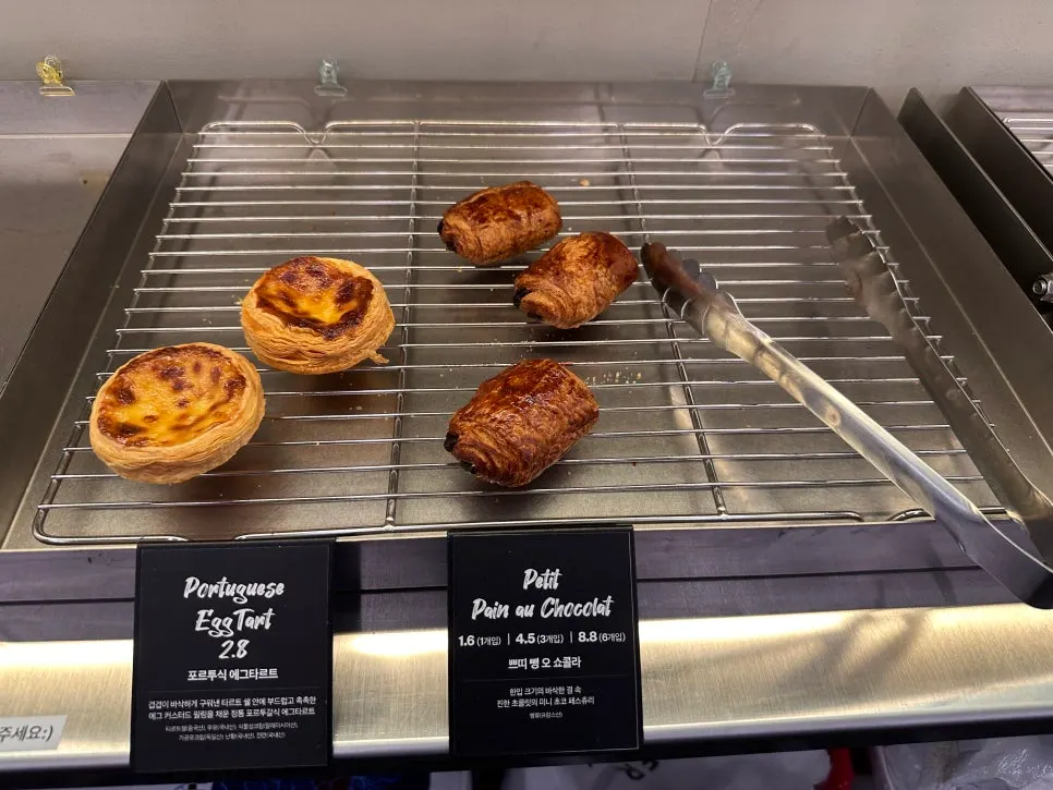 Bakery display with egg tarts and pain au chocolat