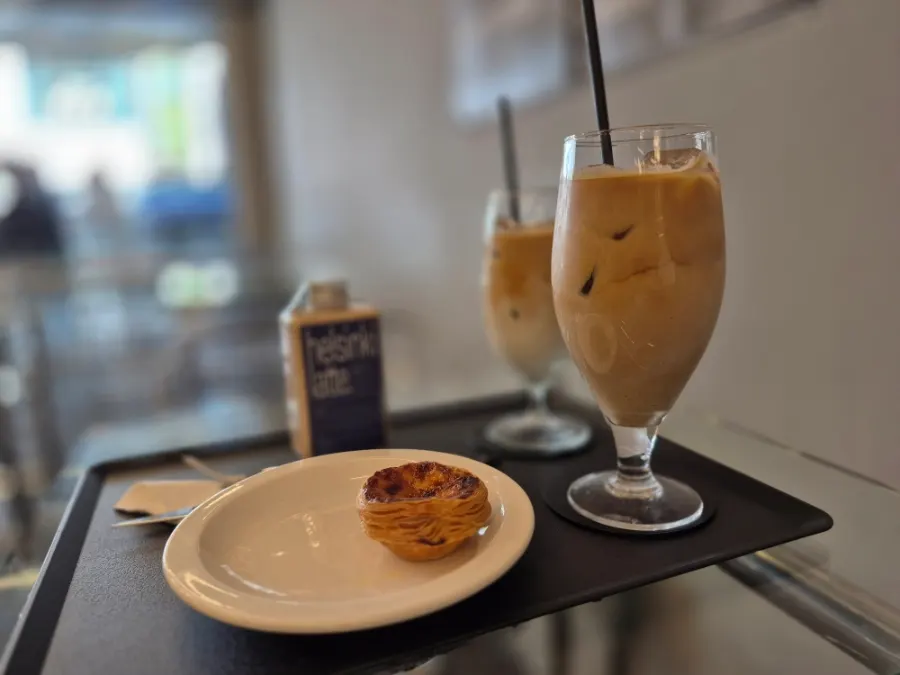 Two Mini Male coffees and egg tart on the table