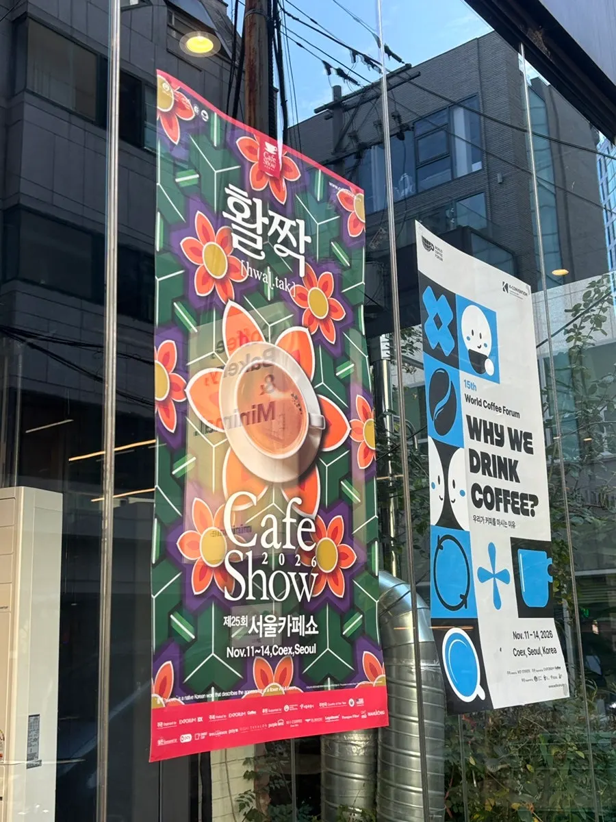 Seoul Cafe Show Official Partner Shop poster at the café entrance
