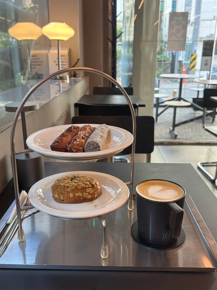 Cookies and baton financiers served on a two-tier tray