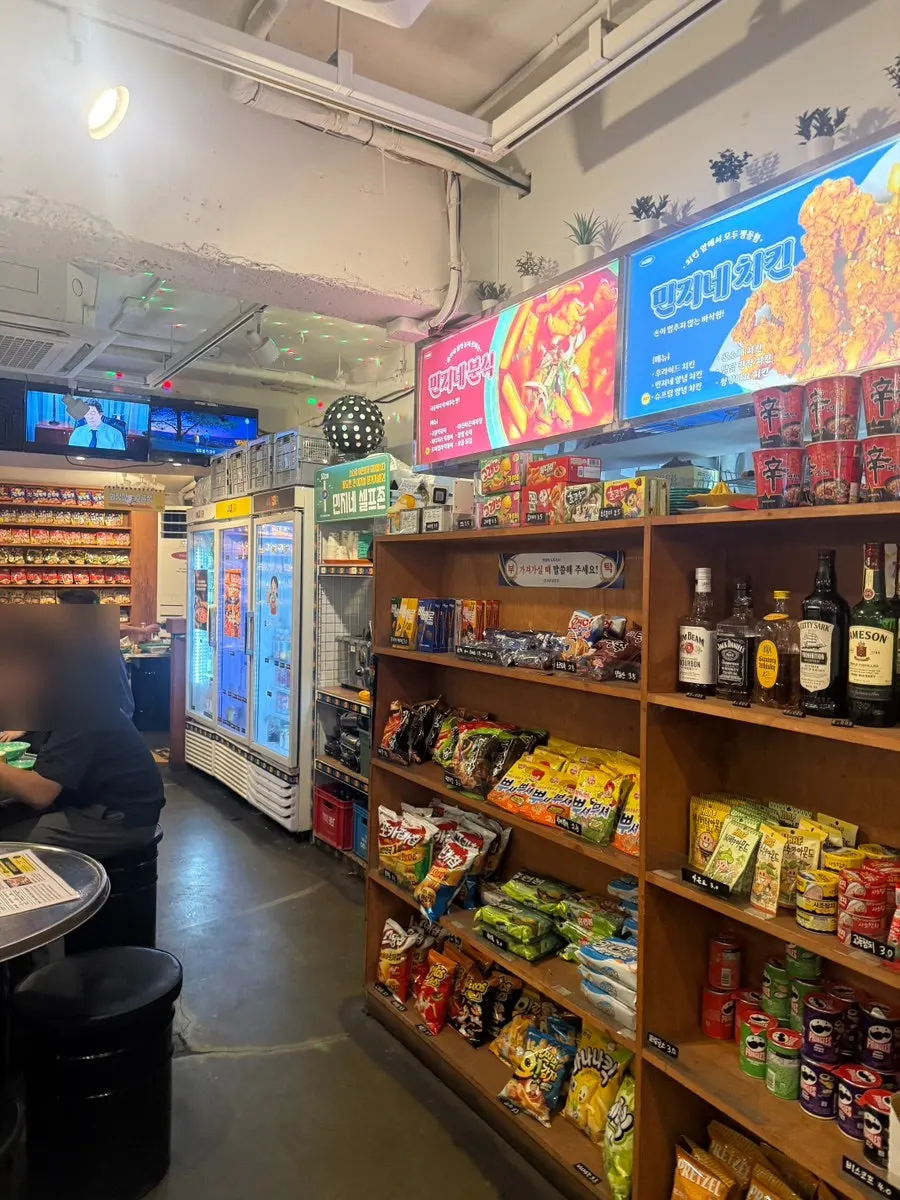 Entrance and outdoor tent seating of Minji Superette in a Konkuk-ip-gu alley