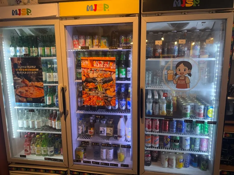 Drinks counter at Minji Superette with soju, beer, and highballs