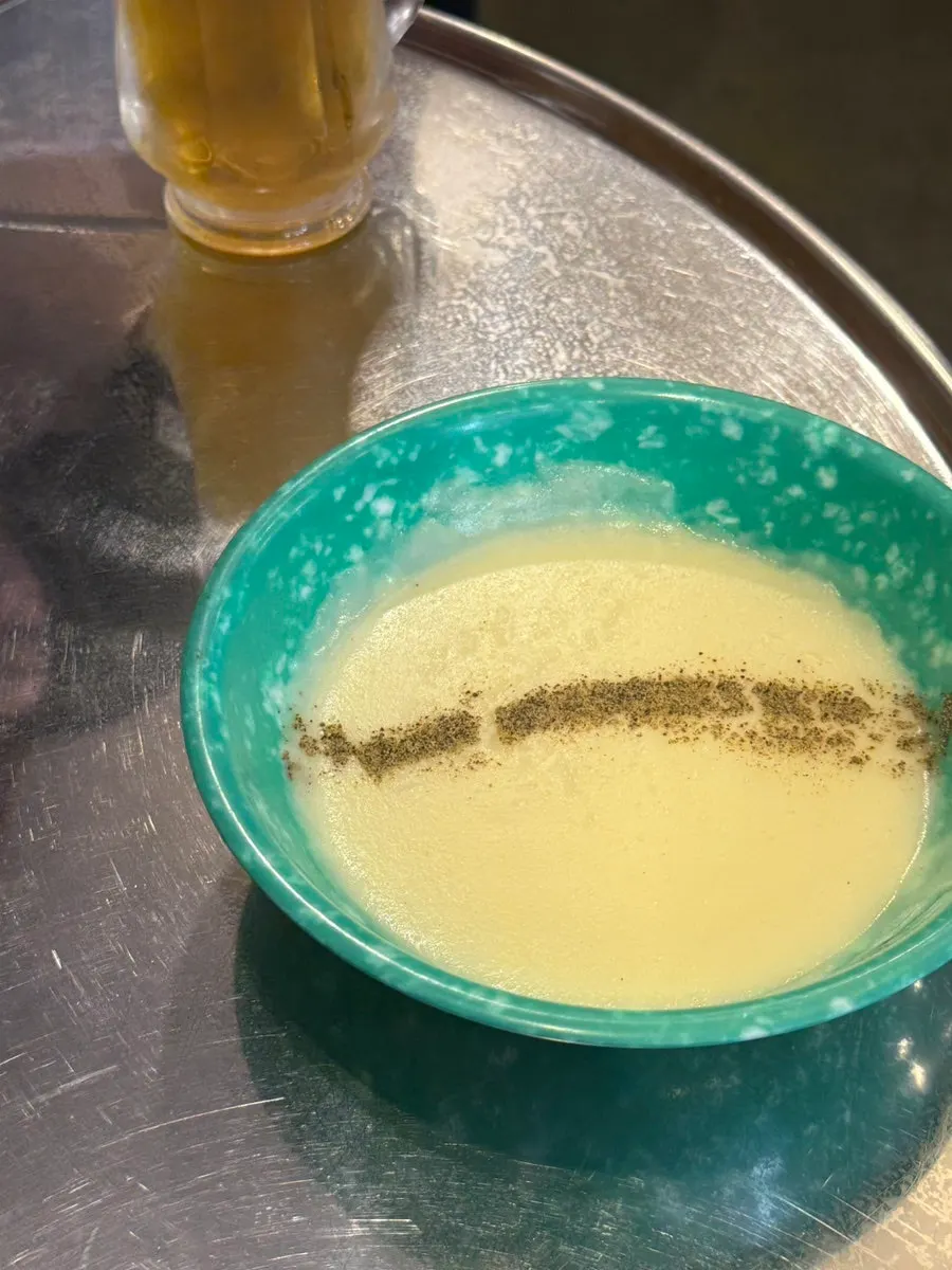 A cup of complimentary cream soup served first