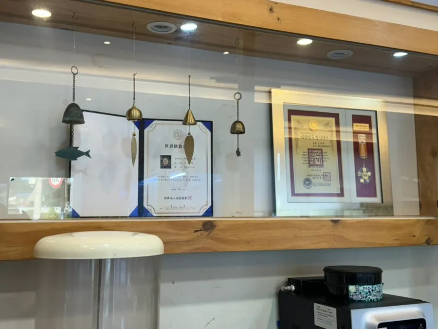 Interior with a sign introducing the Japanese-cuisine master