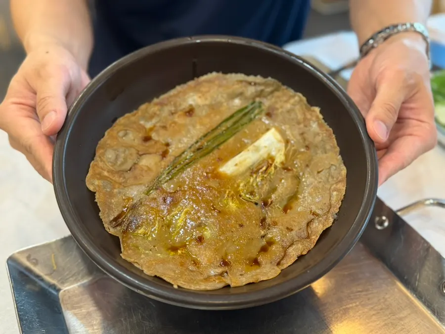 Thin, crisp buckwheat pancake served first