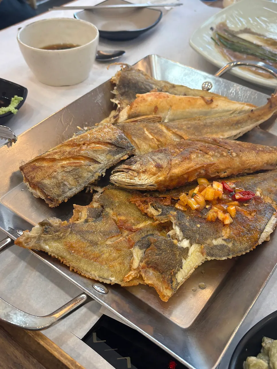 A bite of fish dipped in soy sauce