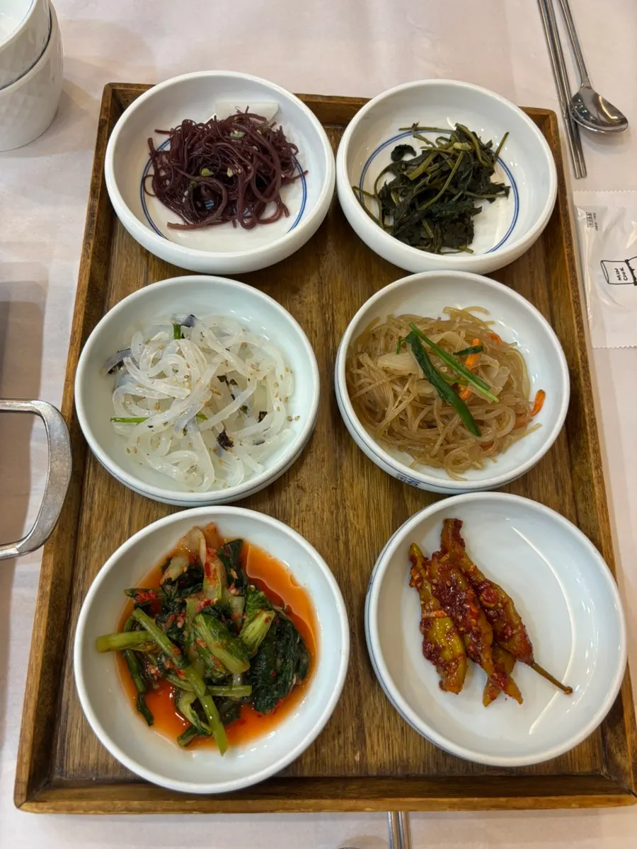 Banchan spread set out after ordering at Min Cook Apbadang