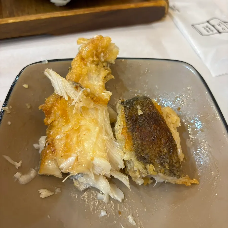 Plate of grilled flounder being deboned