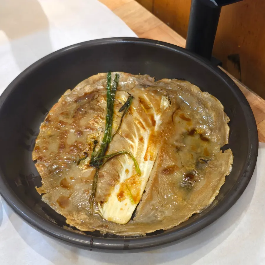 Savory cabbage buckwheat pancake and seasonal side dishes on the table