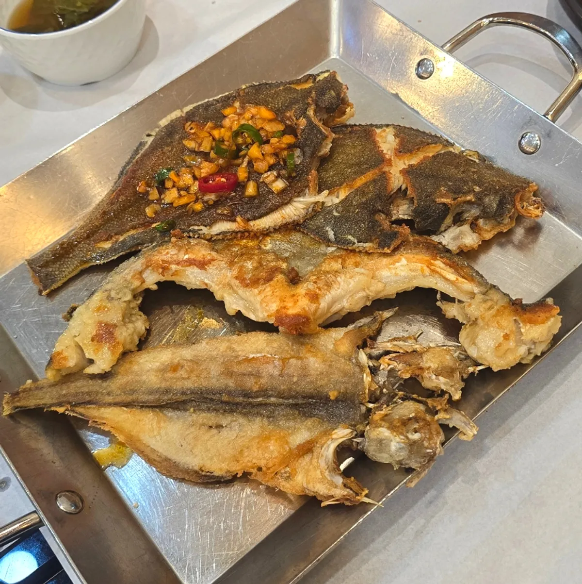 A plate of grilled fish from the set for two