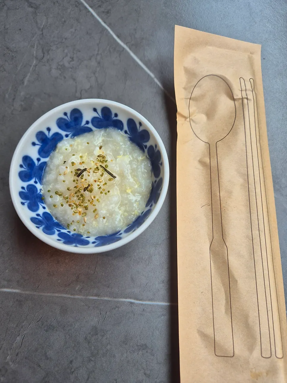 Min Cook Dasima's egg porridge topped with sesame seeds and seaweed flakes