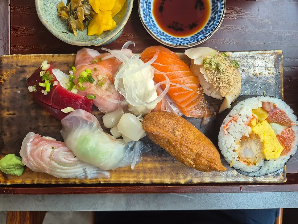 Sushi plate with salmon, tuna, inari sushi, and rolls