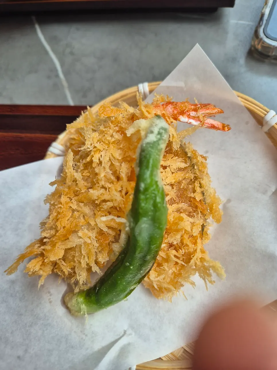 Fried shrimp, shishito pepper, and sweet pumpkin fritters in a basket