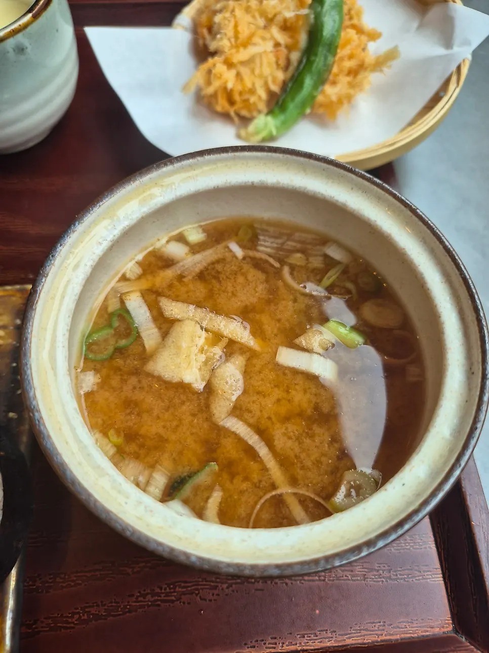 Warm Japanese-style soup with green onion and fried tofu pouch