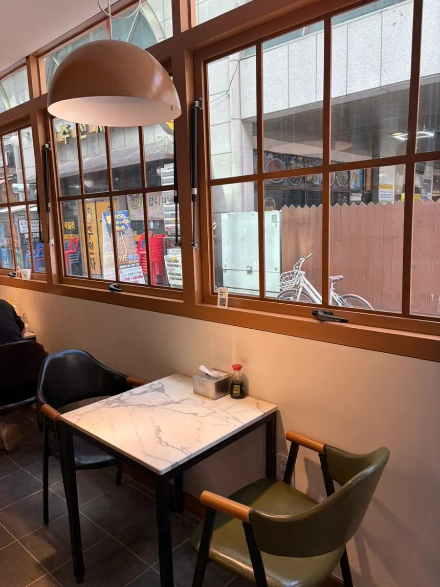 Bar-style seating with the kitchen visible inside