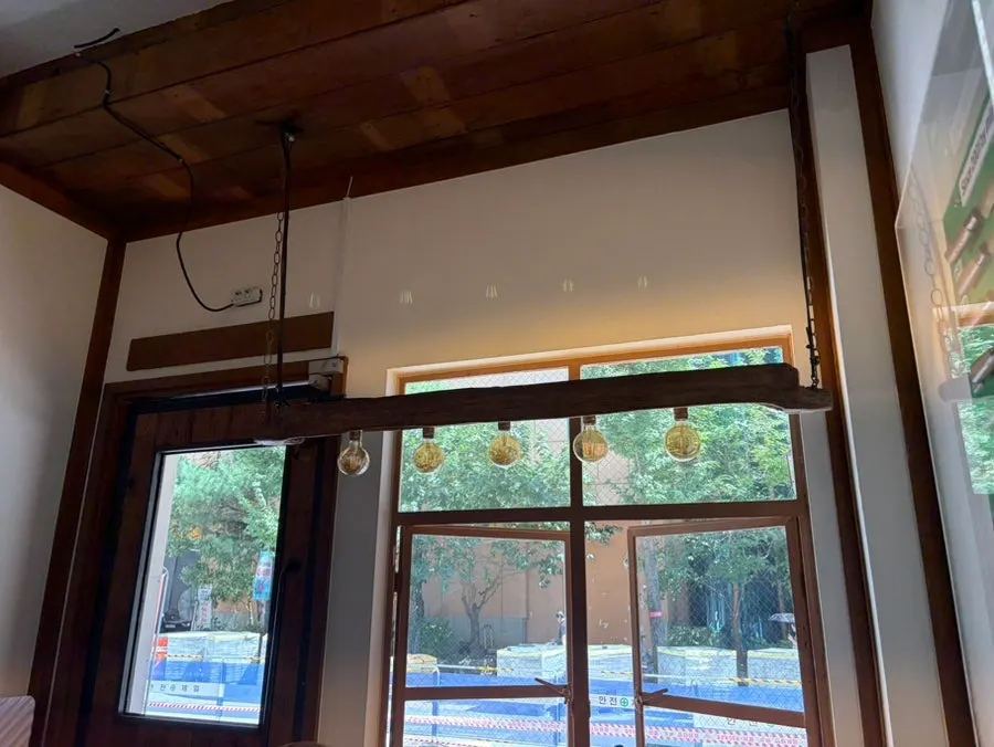 Knives displayed on the wall by the entrance, with light bulbs