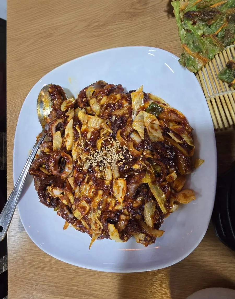 Full spread of the bokkeum set with stir-fried octopus, minari pancake and steamed egg