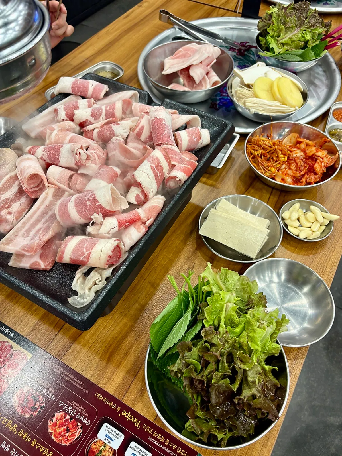 Plate piled with lettuce wraps and side dishes
