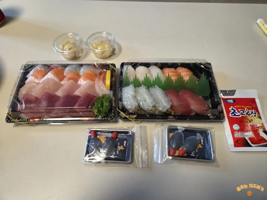 Takeout containers of 1-person sashimi and special mixed sushi
