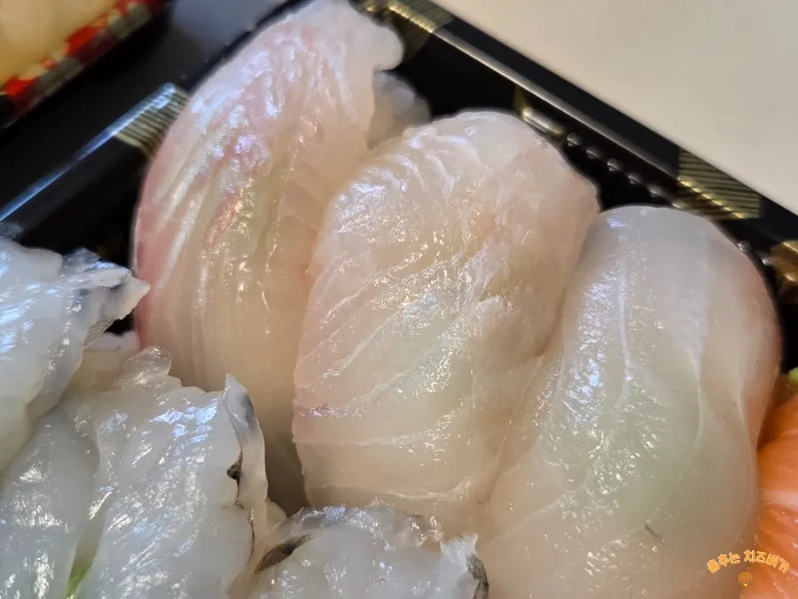 A generous spread of sashimi and sushi set out on the table
