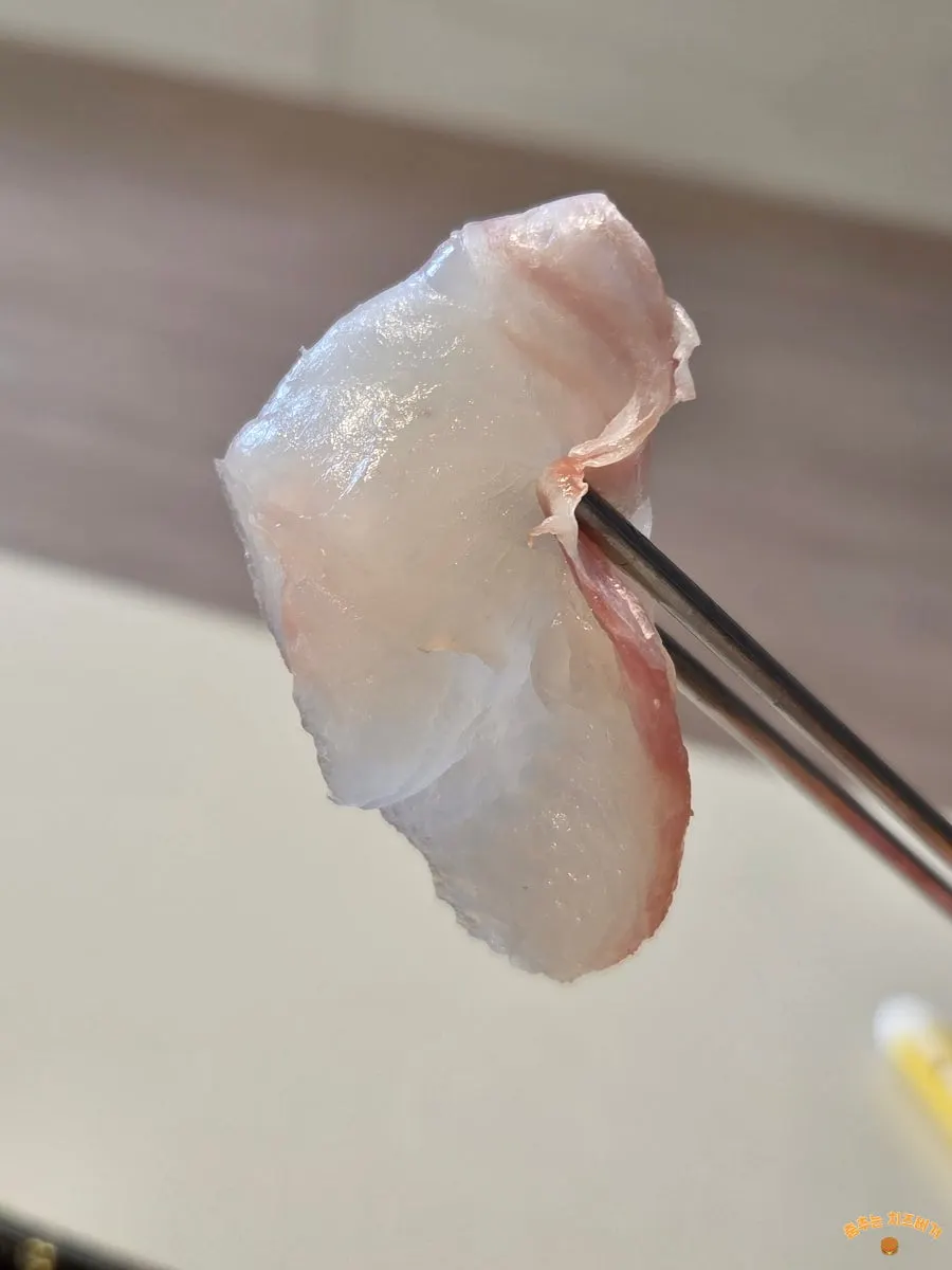 A soft piece of white fish sashimi