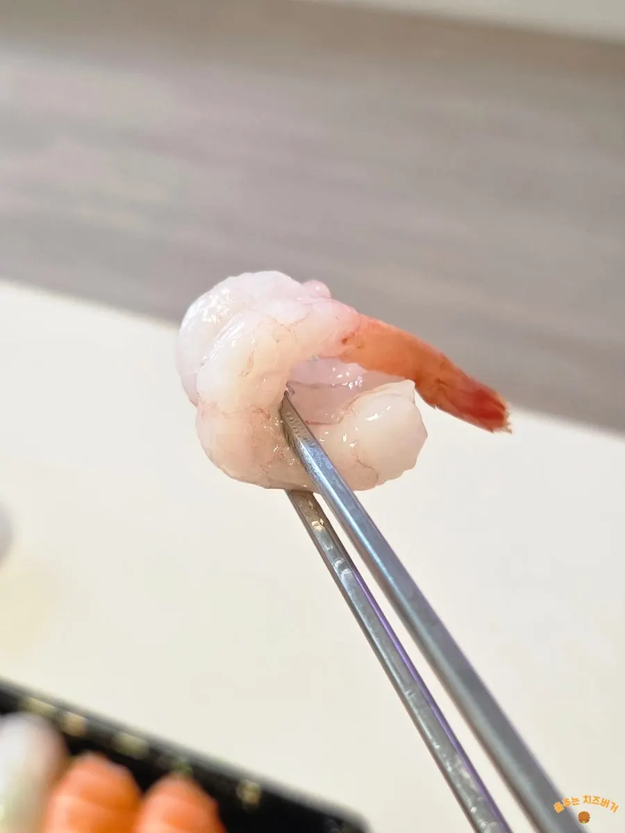 A piece of sashimi served with soy sauce and wasabi