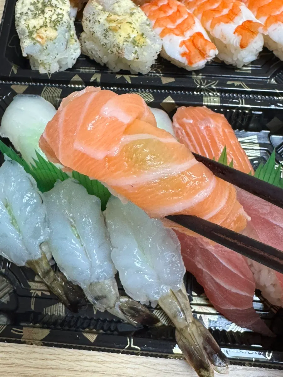 Picking up a bite-sized piece of sushi