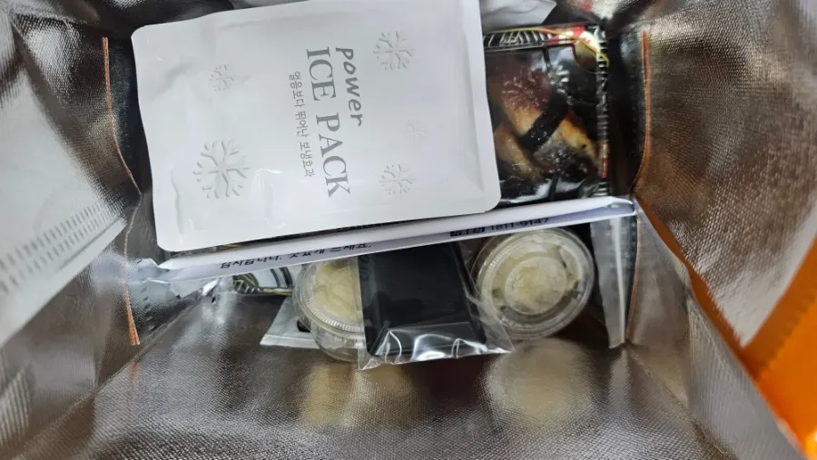 Sushi takeout bag carried along with market groceries