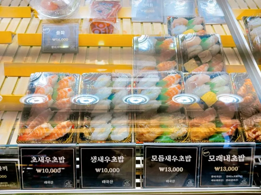 Various sushi arranged in the display fridge
