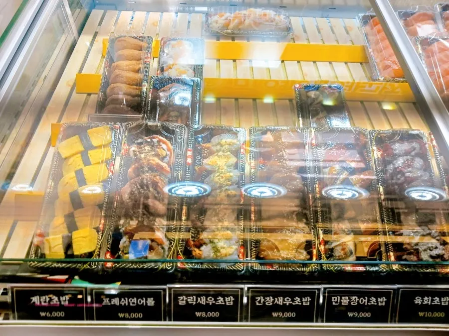 Display case with prices for each type of sushi