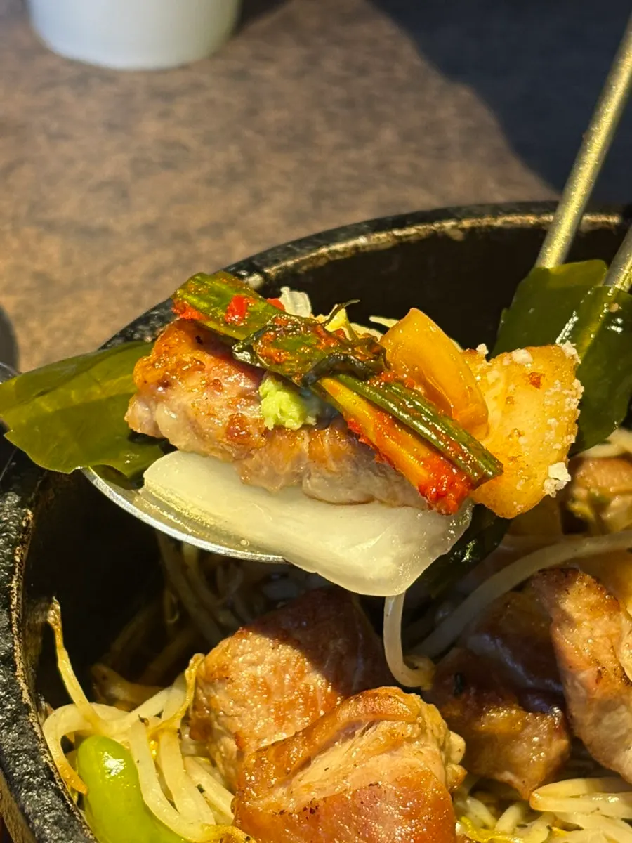 A luxurious wrap topped with myeongi-namul and pa-kimchi