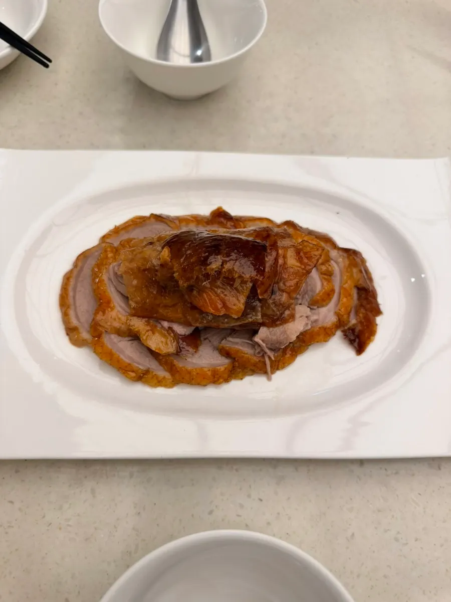 Wrapping Peking duck in a wheat pancake