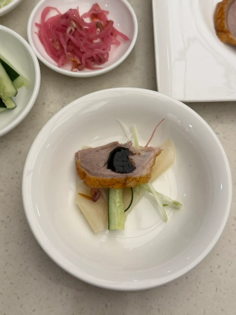 Peking duck wrap topped with sweet bean sauce